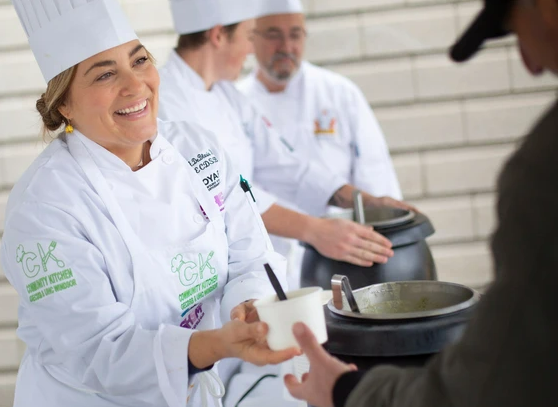 Chef Adelina serving food