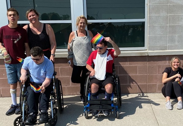 Pride flag raising students and staff