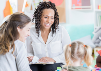 Teacher talking to a parent and their child