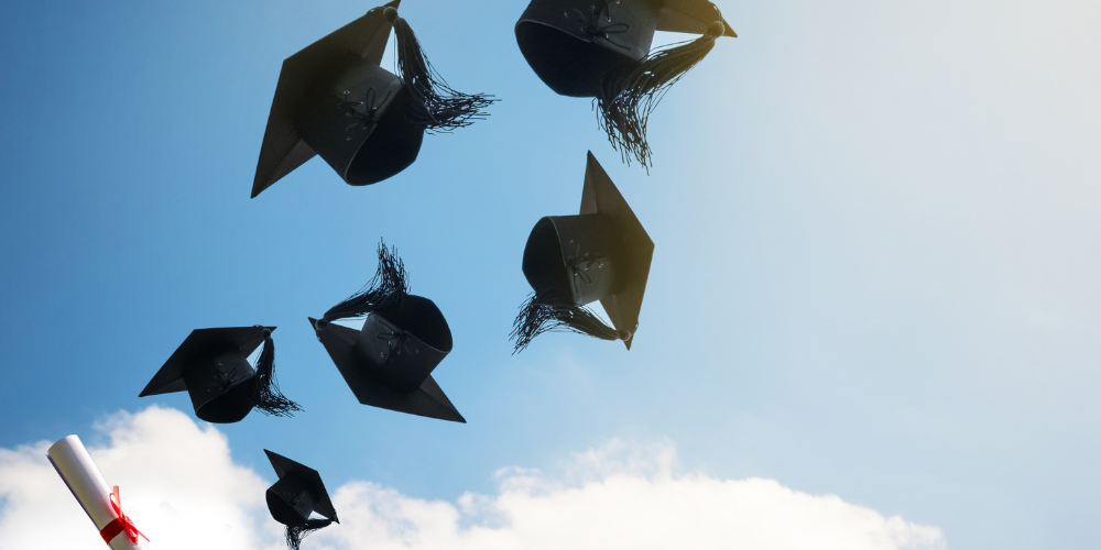 Graduation hats thrown in the air