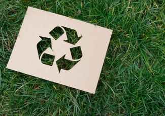 Recycling symbol on grass