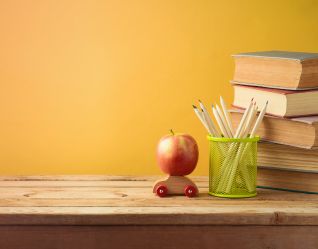Apple, books and pencils