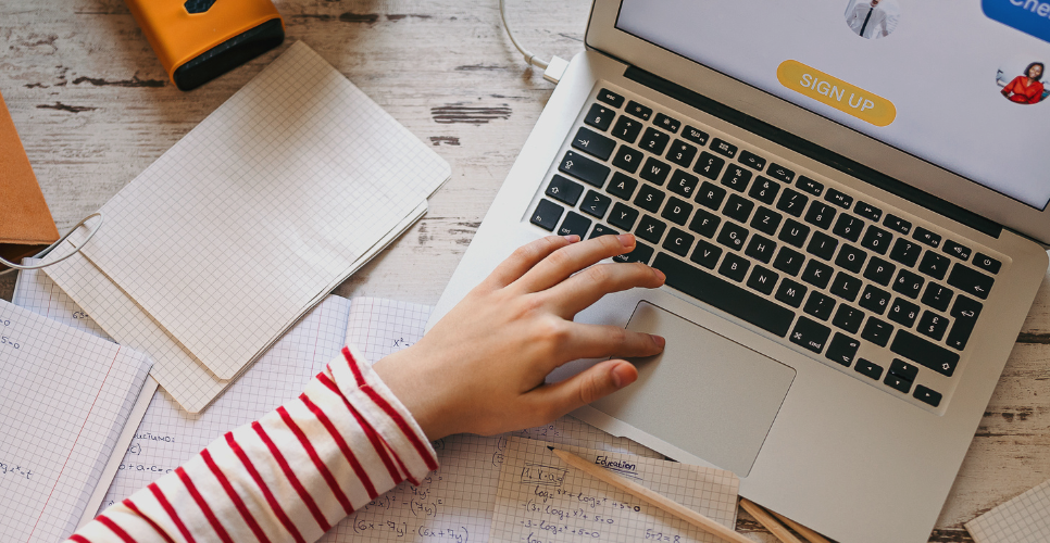 Student typing on a laptop