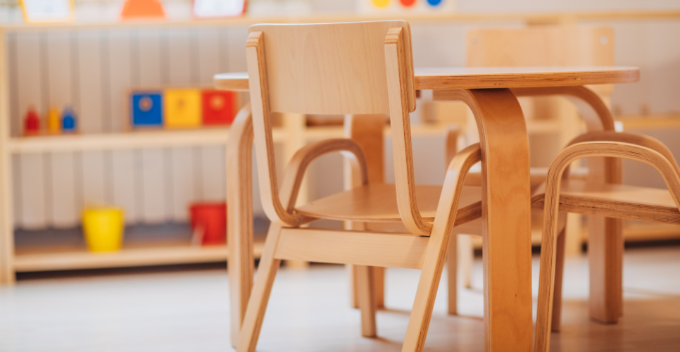 Wooden chairs at a table in a classroom