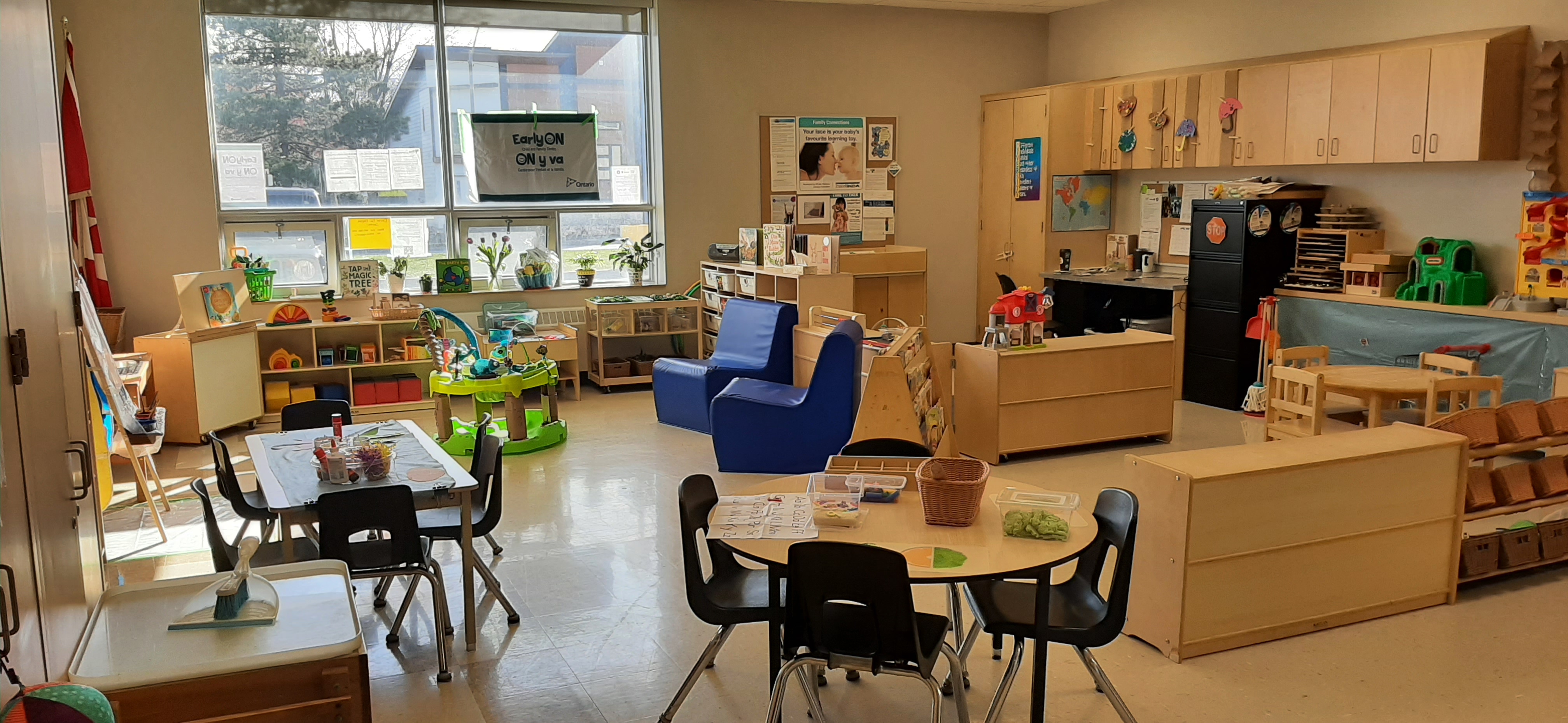 Classroom set up with tables, chairs, toys and leanring activities